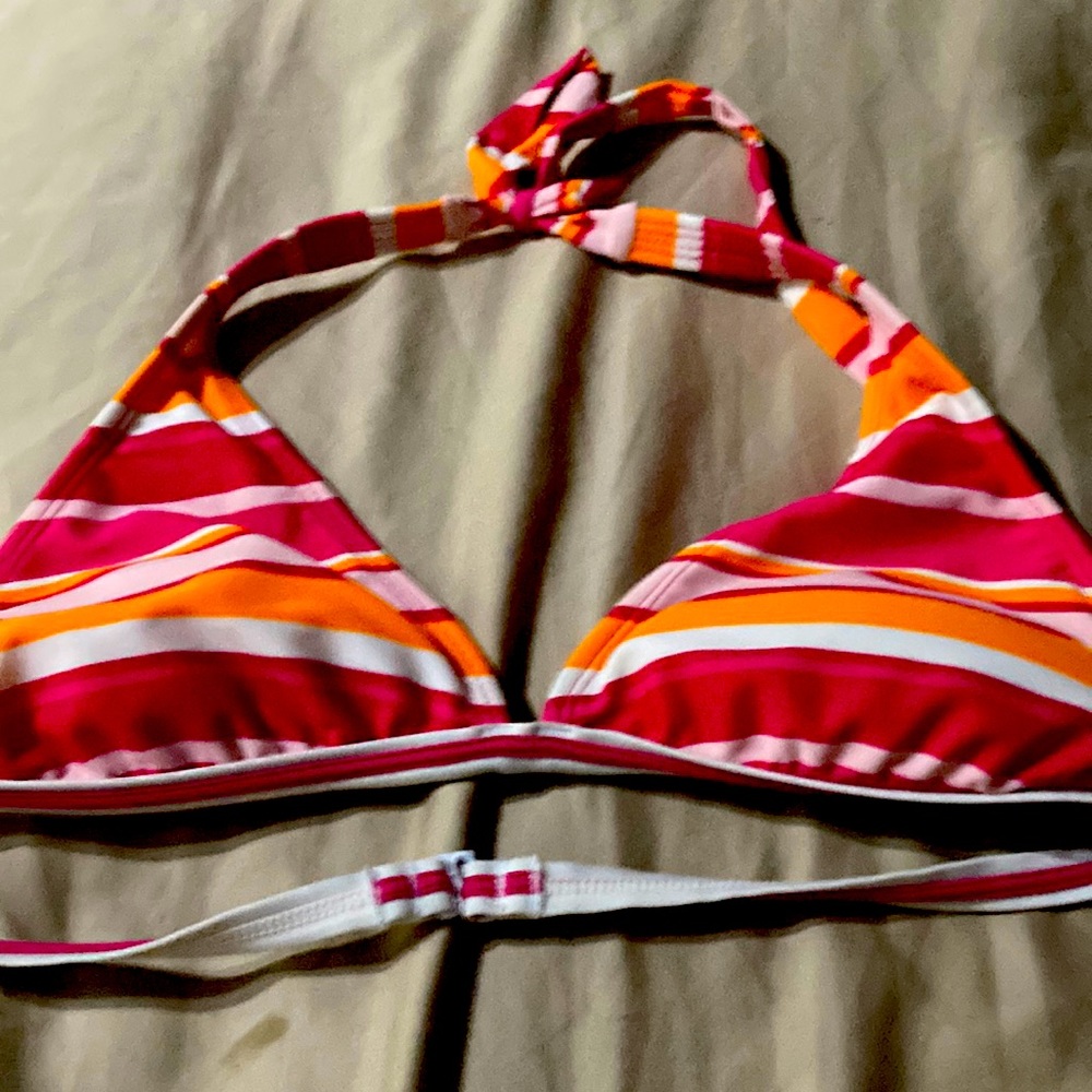 It’s a pink orange and white bikini top and it’s a size small